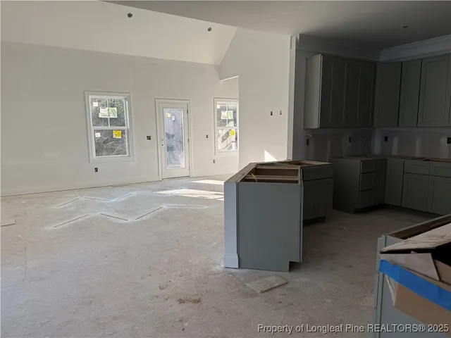 a view of kitchen with cabinets and window