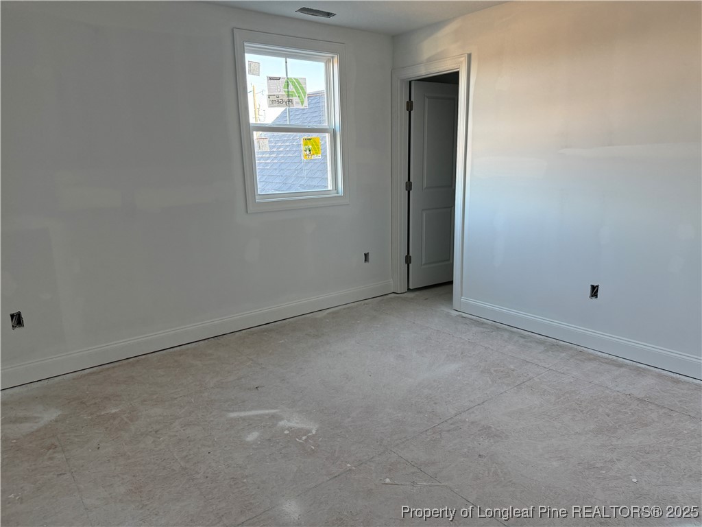 3205 Leaflet Church Road Broadway, NC 27505 - Photo 10 of 12 an empty room with windows and a window