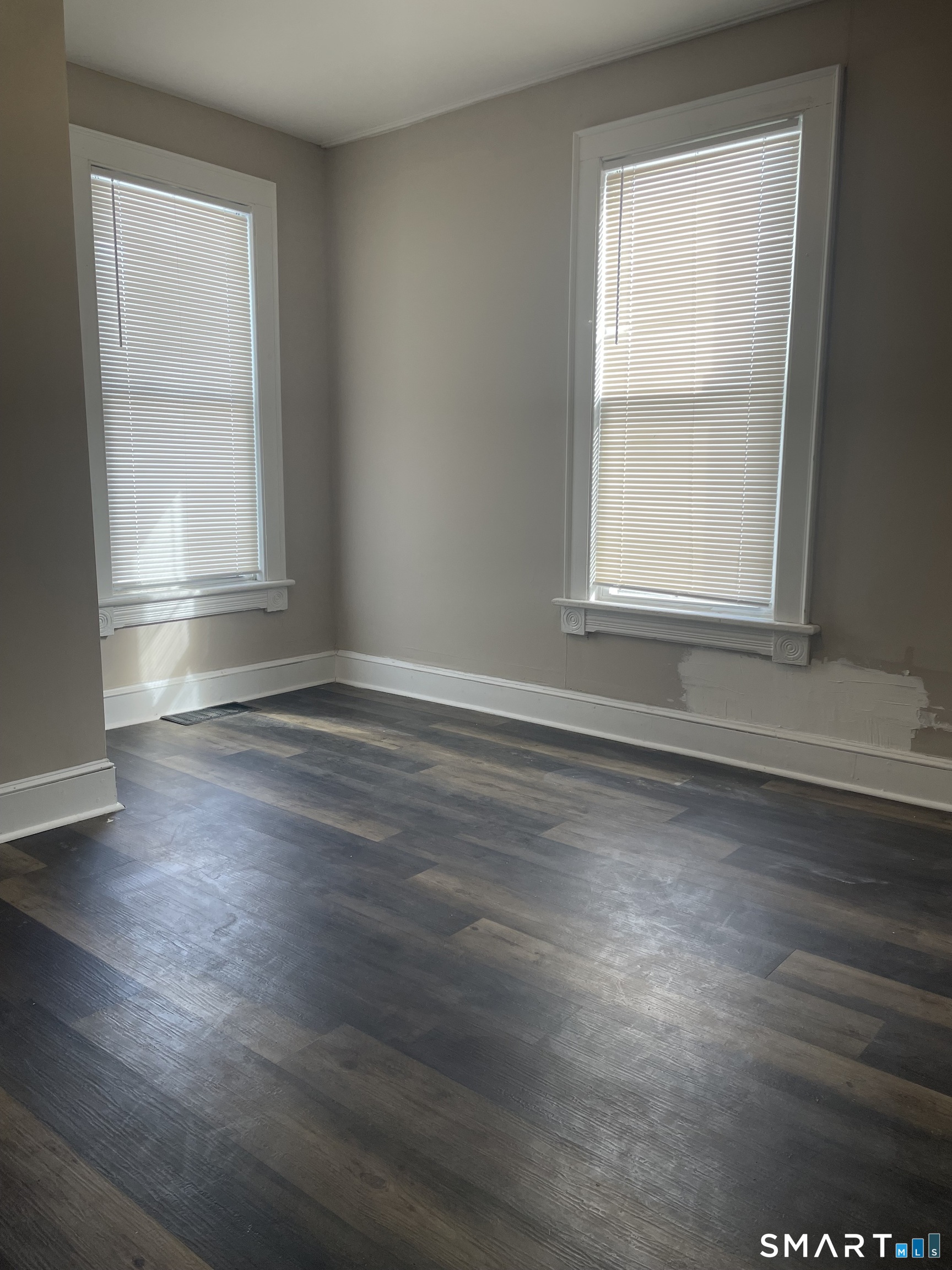 227 Arctic Street Bridgeport, CT 06608 - Photo 11 of 19 an empty room with wooden floor and windows