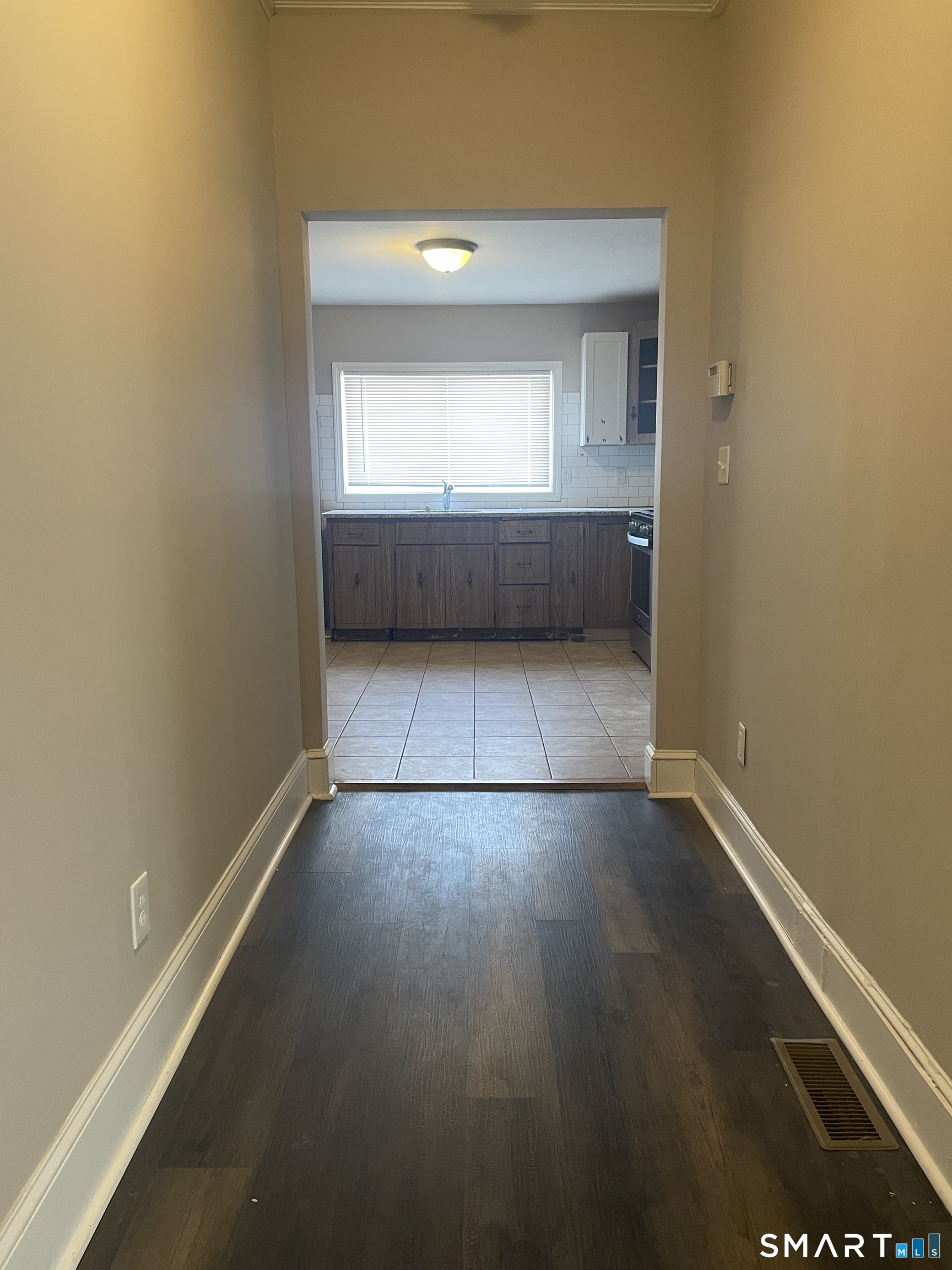 227 Arctic Street Bridgeport, CT 06608 - Photo 14 of 19 an empty room with wooden floor and windows