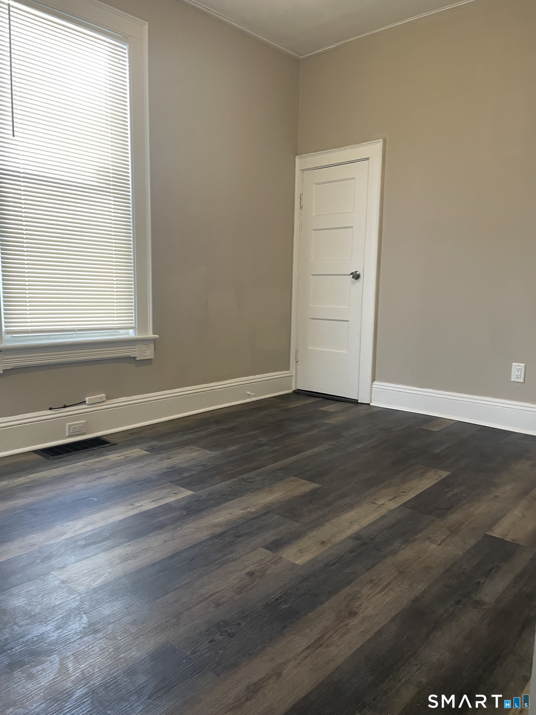 227 Arctic Street Bridgeport, CT 06608 - Photo 7 of 19 an empty room with wooden floor and window