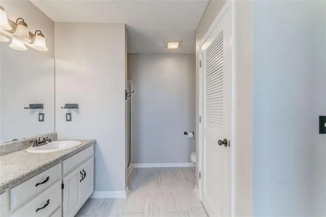 an empty room with wooden floor and a ceiling fan