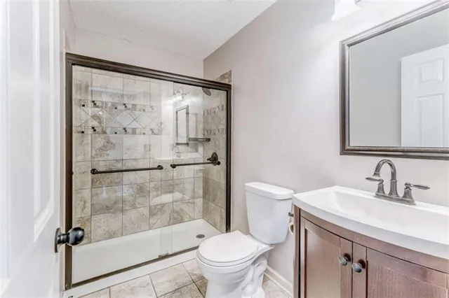 a view of empty room with wooden floor and window
