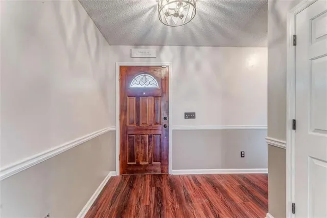 a kitchen with granite countertop a sink window and cabinets