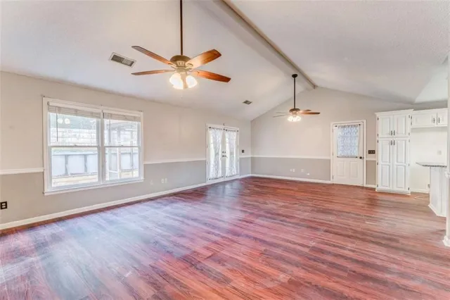 a view of a pathway of a house with wooden fence