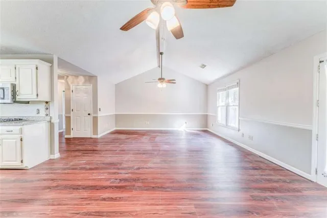 a view of a house with a yard and sitting area