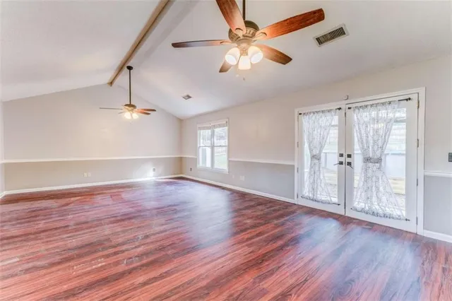 a view of a house with a yard and wooden fence