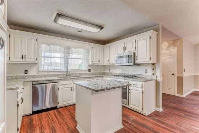 a view of a yard with wooden fence