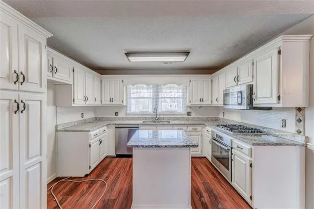 a view of a yard with wooden fence and trees