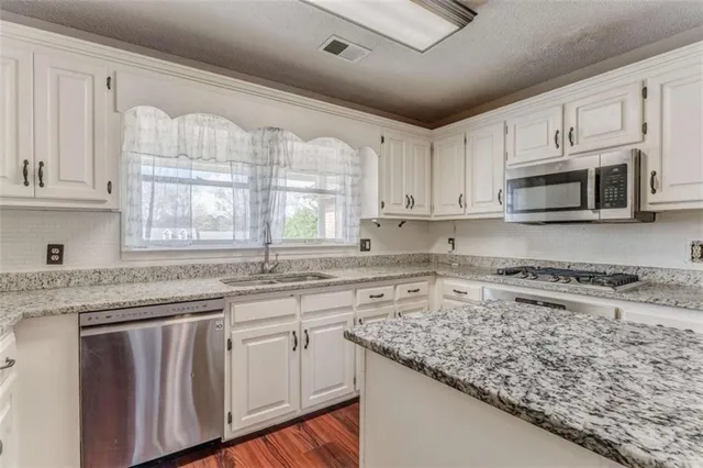 a view of an house with backyard and wooden fence