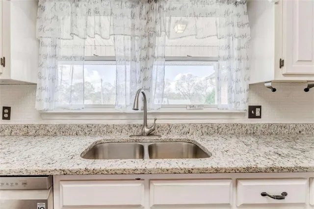 a view of a backyard with wooden fence