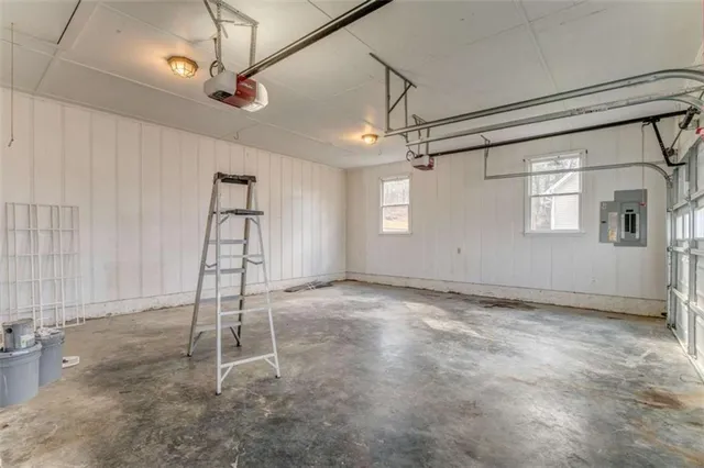 a view of a house with a roof and wooden fence