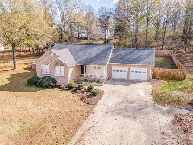 a wooden bench sitting in the middle of a yard