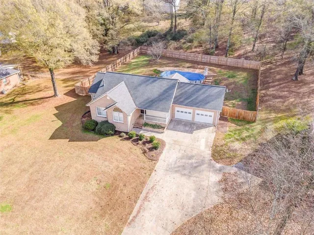 a view of a house with a yard and sitting area