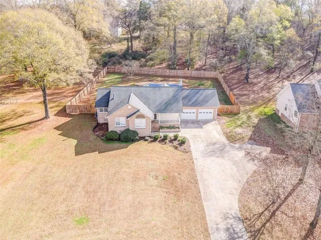 a view of a dry yard with lots of trees