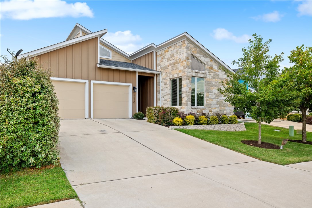7220 Cardinal Bloom Loop Austin, TX 78744 - Photo 1 of 1 a front view of house with garage and yard