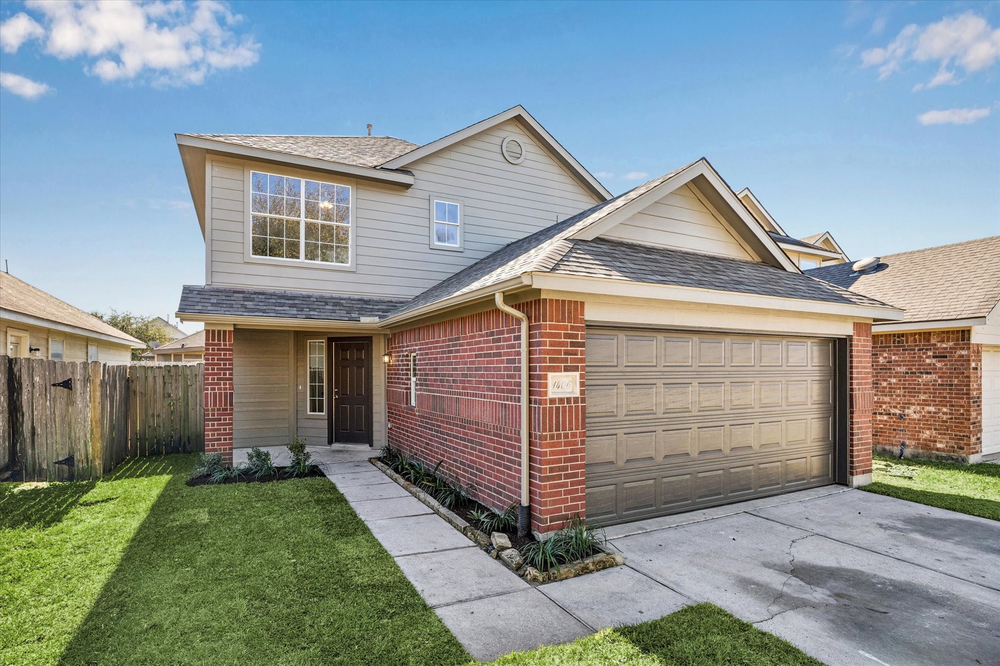 a front view of a house with a garden