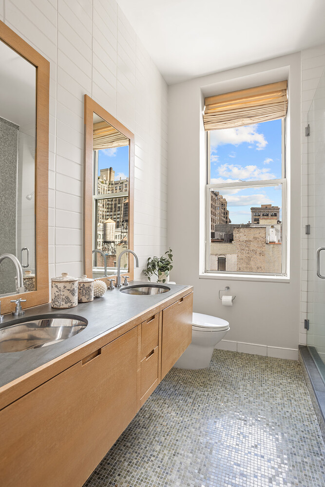 49 East 21st Street, Unit 11B Manhattan, NY 10010 - Photo 7 of 12 a bathroom with a granite countertop sink toilet and large window