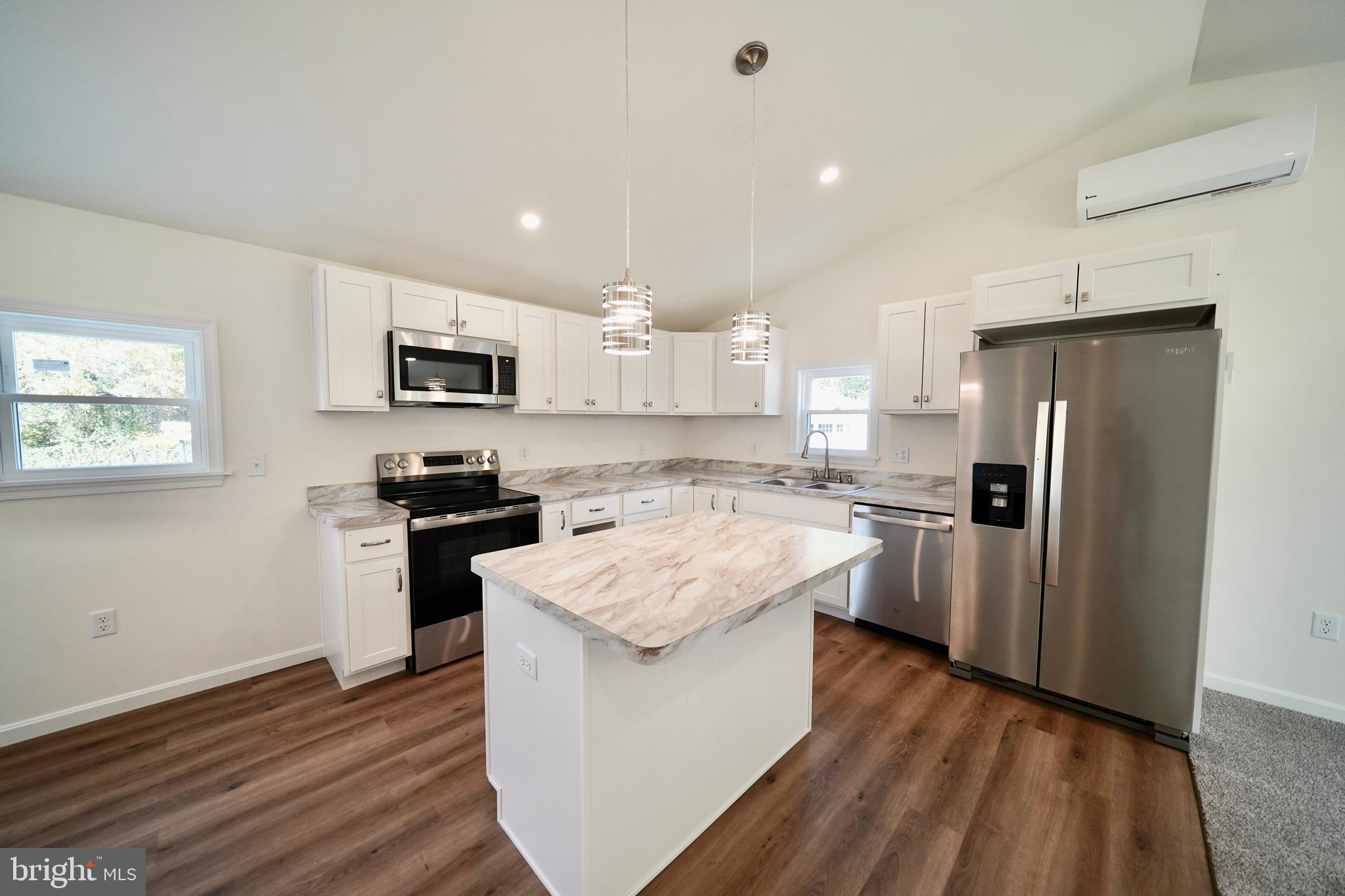 1465 Millington Road Clayton, DE 19938 - Photo 11 of 31 a kitchen with a refrigerator stove and sink