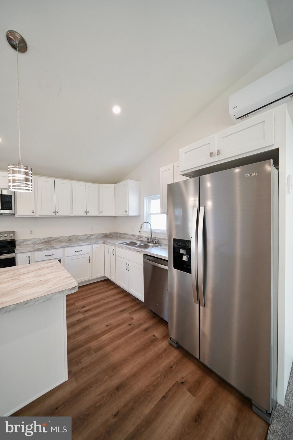 1465 Millington Road Clayton, DE 19938 - Photo 13 of 31 a kitchen with a refrigerator sink and cabinets