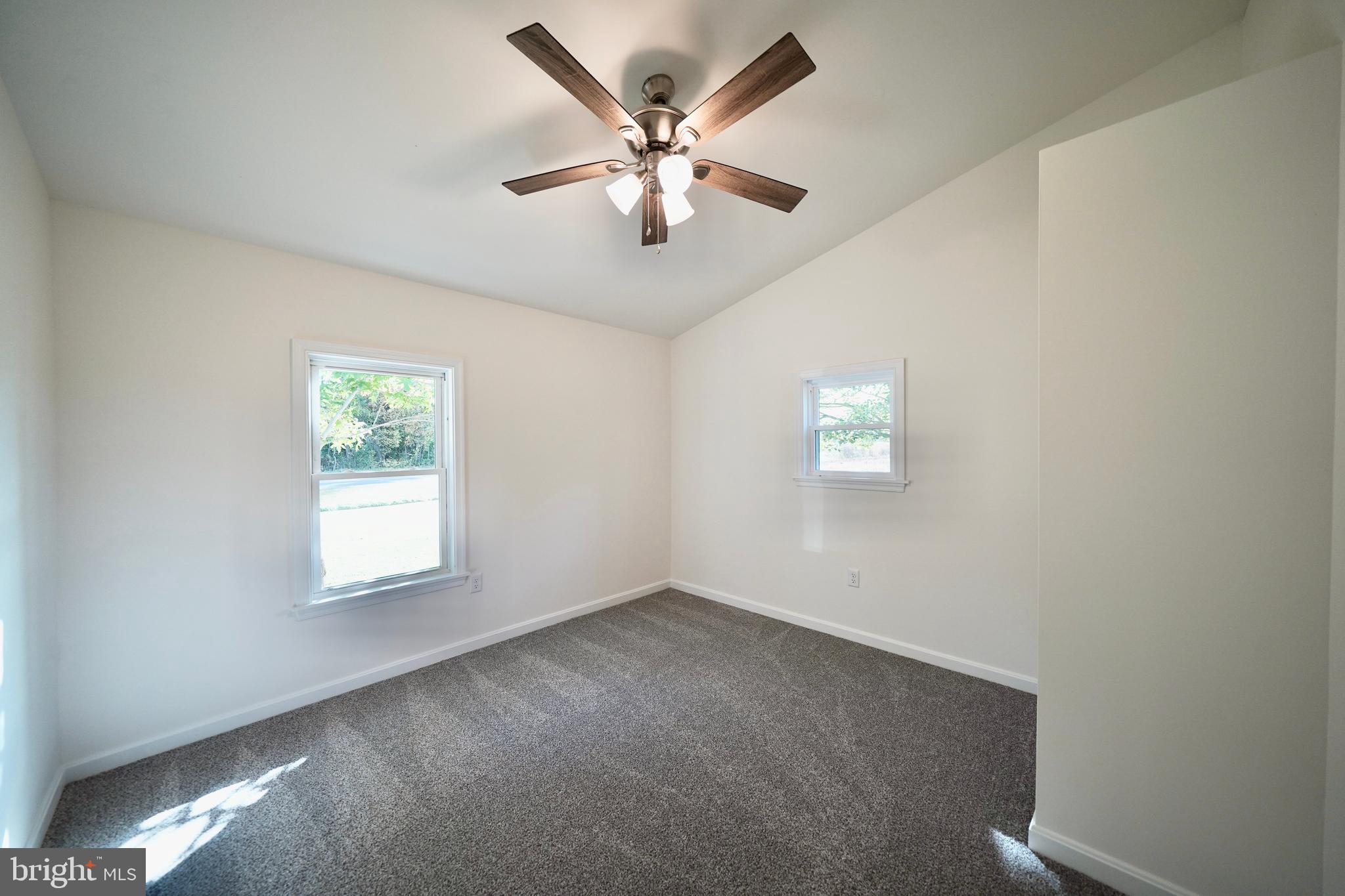 1465 Millington Road Clayton, DE 19938 - Photo 19 of 31 an empty room with windows and ceiling fan
