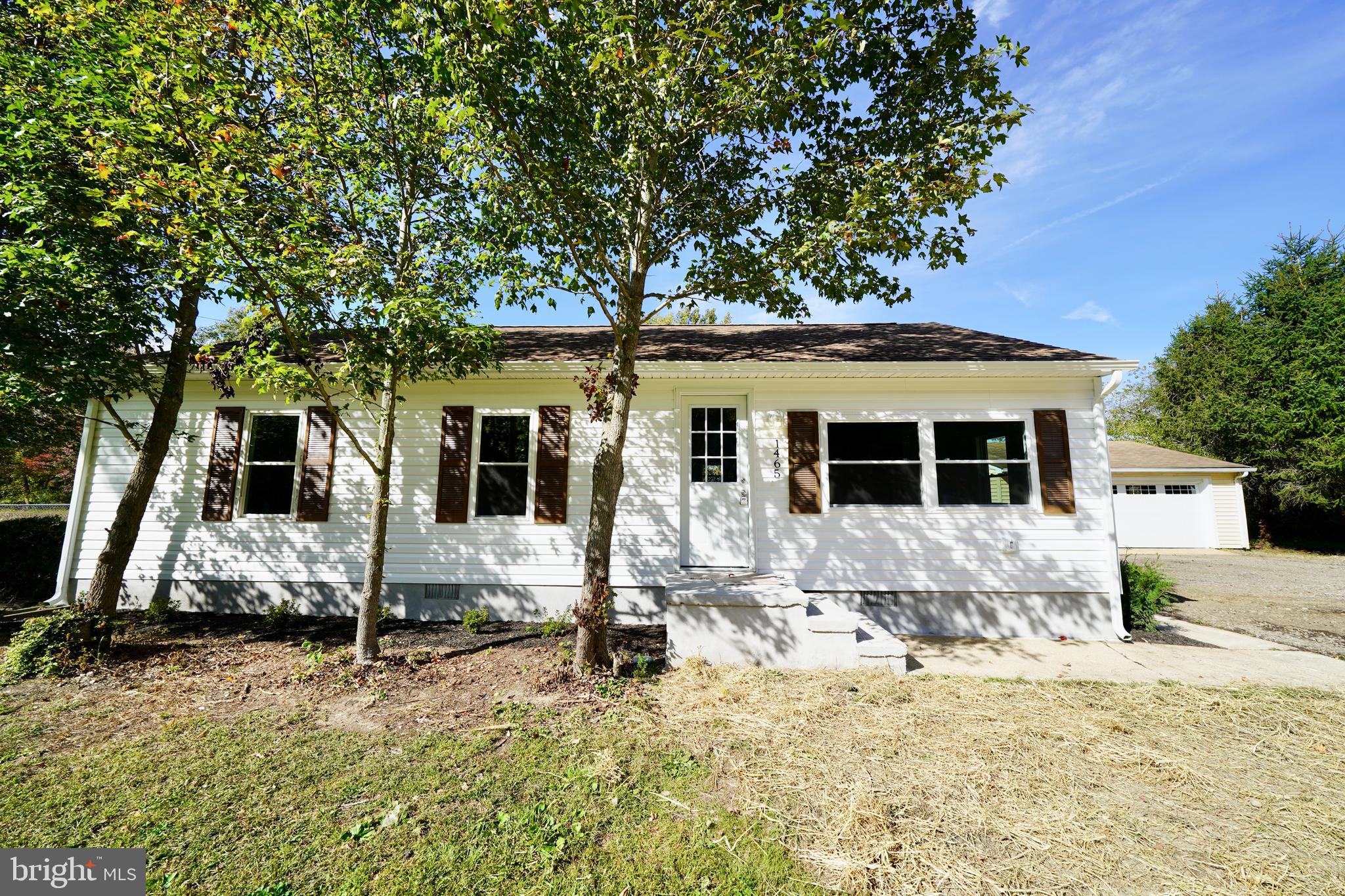 1465 Millington Road Clayton, DE 19938 - Photo 4 of 31 a front view of a house with a yard covered with snow in front of house