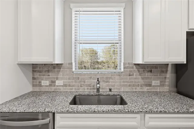 a kitchen with sink and wooden floor