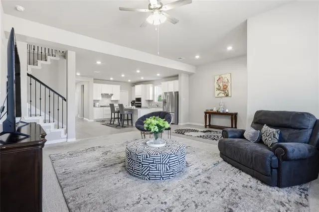 a living room with furniture and a chandelier
