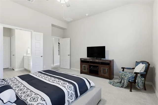 a bedroom with a bed and a television