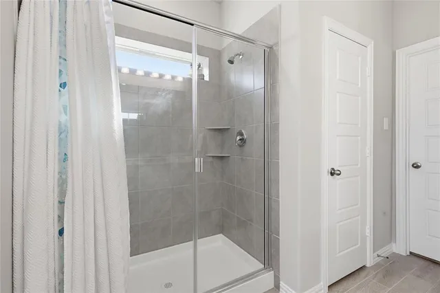a bathroom with a glass shower door