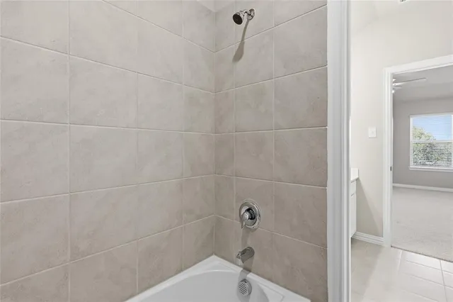 a bathroom with a bathtub and shower