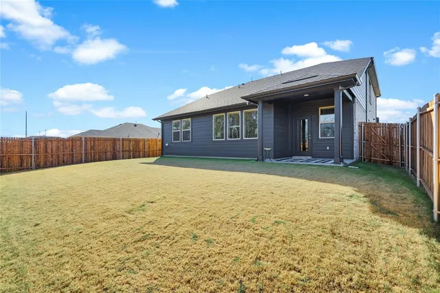 a view of an house with backyard of house