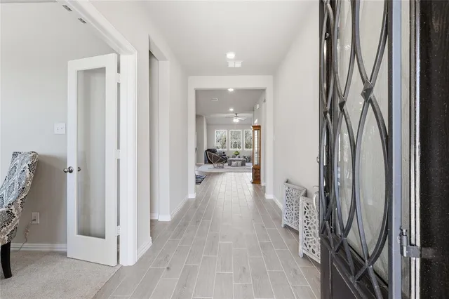 a view of a hallway and a livingroom with furniture