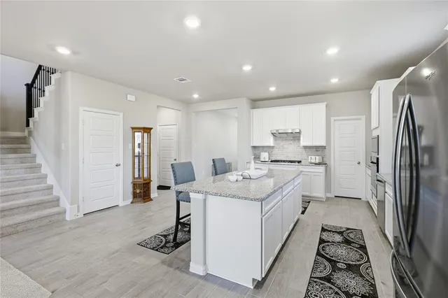 a kitchen with a sink stainless steel appliances and counter space