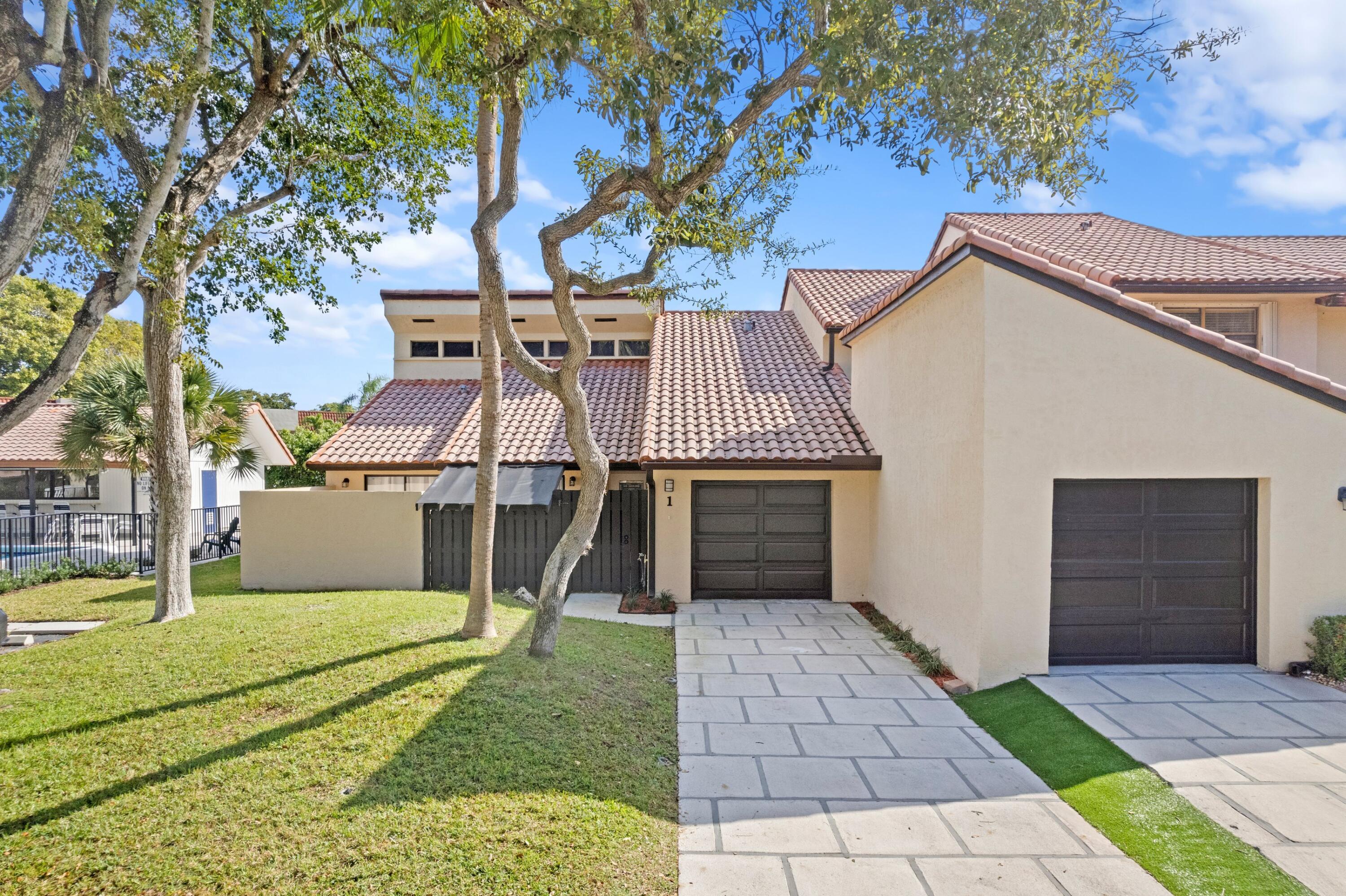 6850 Northwest 2nd Avenue, Unit 1 Boca Raton, FL 33487 - Photo 1 of 31 a view of a house with a yard
