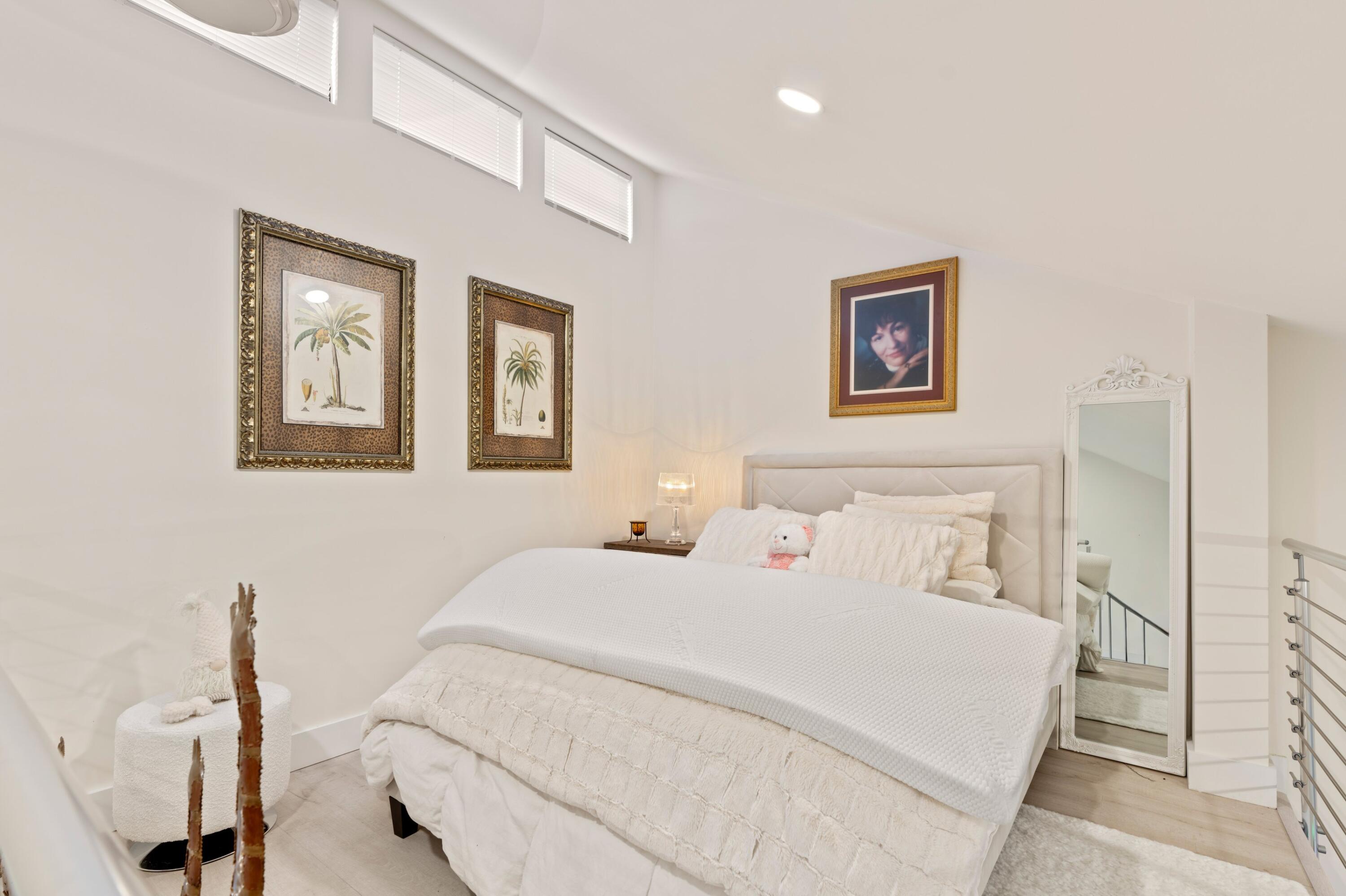 6850 Northwest 2nd Avenue, Unit 1 Boca Raton, FL 33487 - Photo 16 of 31 a bedroom with a bed and a painting on the wall