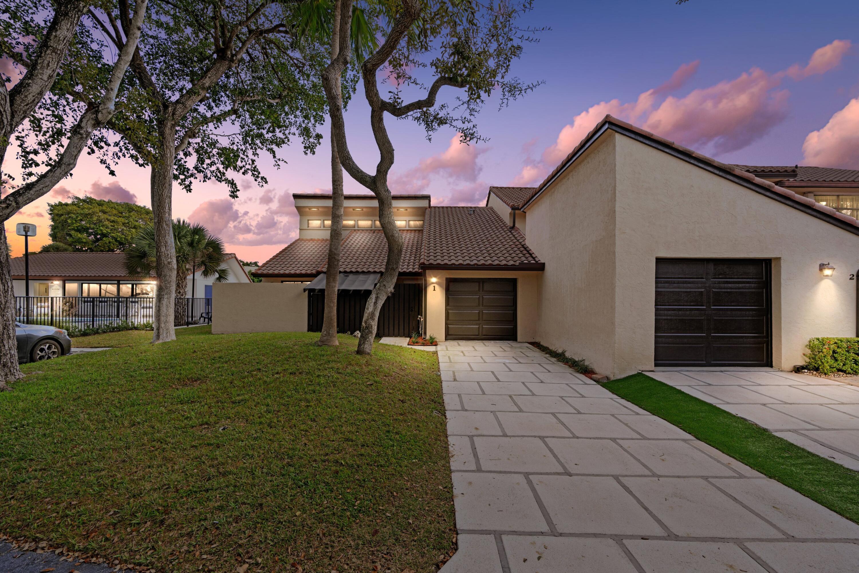6850 Northwest 2nd Avenue, Unit 1 Boca Raton, FL 33487 - Photo 24 of 31 a front view of a house with garden