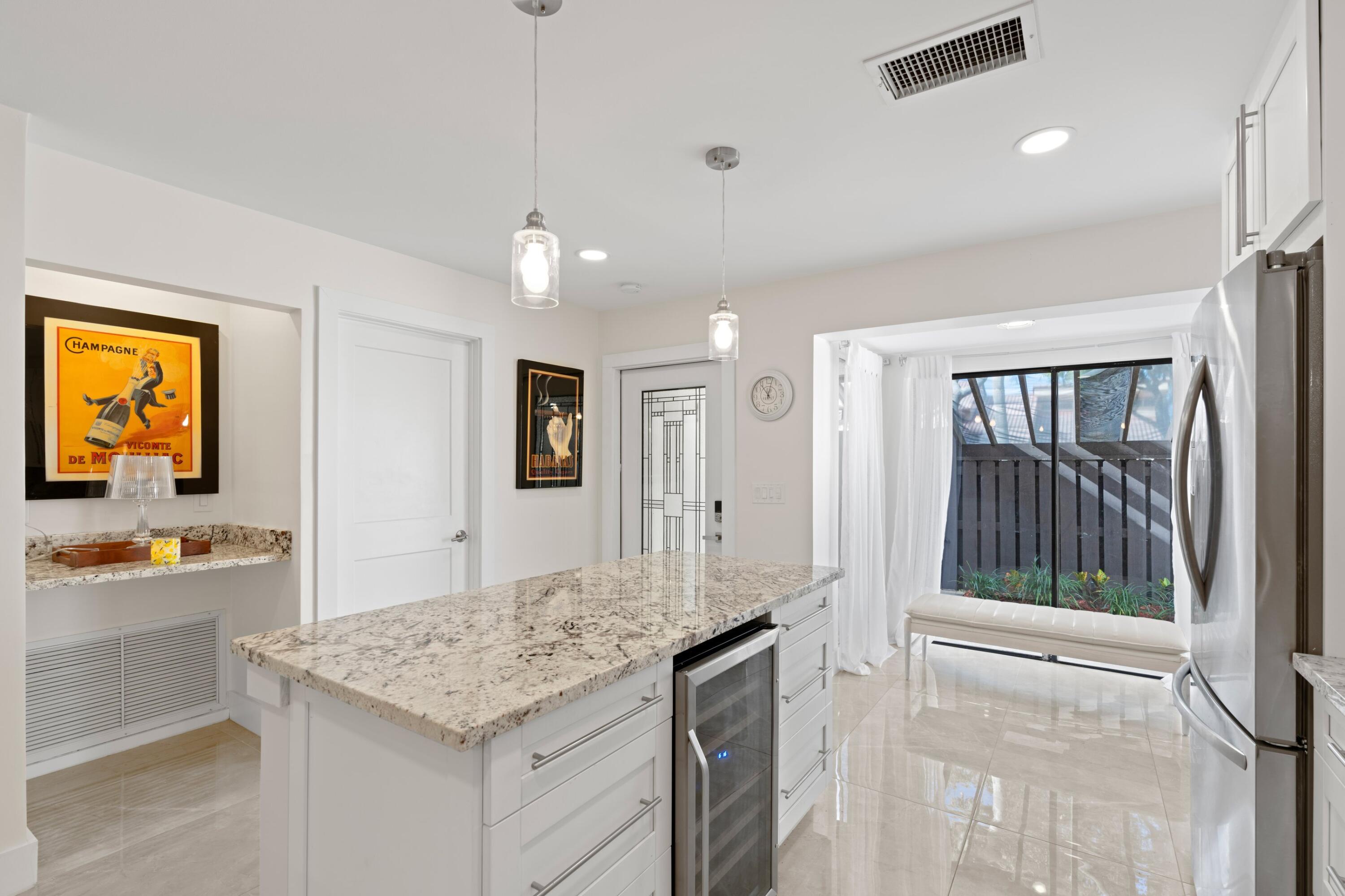 6850 Northwest 2nd Avenue, Unit 1 Boca Raton, FL 33487 - Photo 3 of 31 a bathroom with a granite countertop sink and a mirror