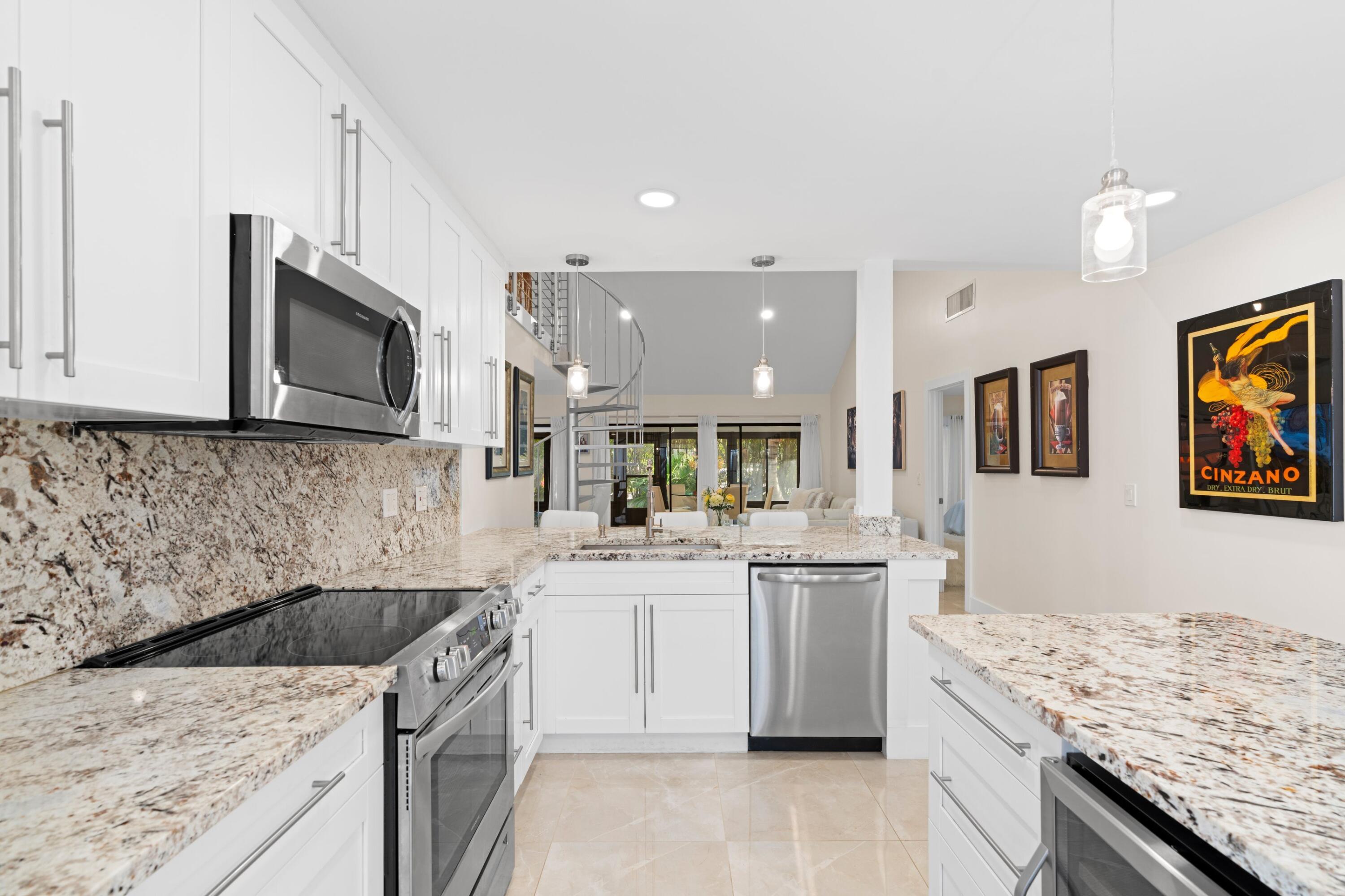 6850 Northwest 2nd Avenue, Unit 1 Boca Raton, FL 33487 - Photo 6 of 31 a kitchen with stainless steel appliances granite countertop a sink stove and microwave