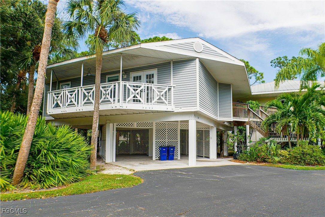 a front view of a house with a garden and plants