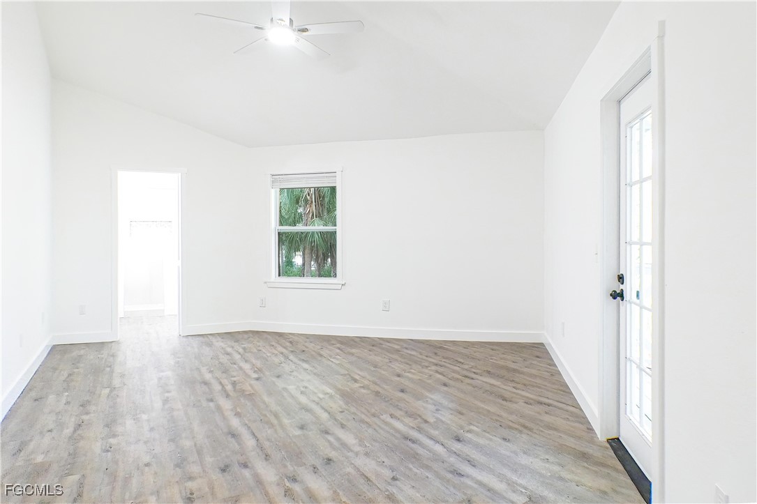 950 Moody Road, Unit 108 North Fort Myers, FL 33903 - Photo 16 of 21 an empty room with wooden floor and windows