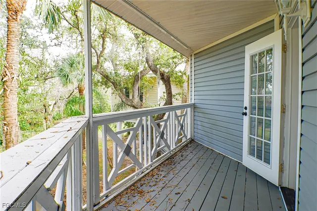 a view of balcony with wooden floor and fence