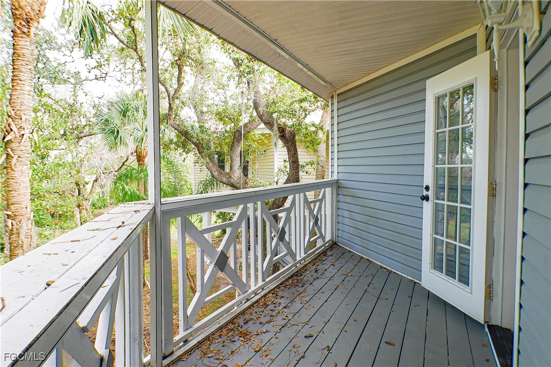 950 Moody Road, Unit 108 North Fort Myers, FL 33903 - Photo 19 of 21 a view of balcony with wooden floor and fence