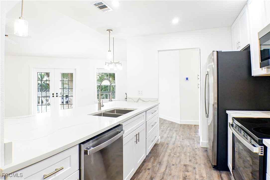 950 Moody Road, Unit 108 North Fort Myers, FL 33903 - Photo 3 of 21 a kitchen with a sink a counter top space stainless steel appliances and cabinets