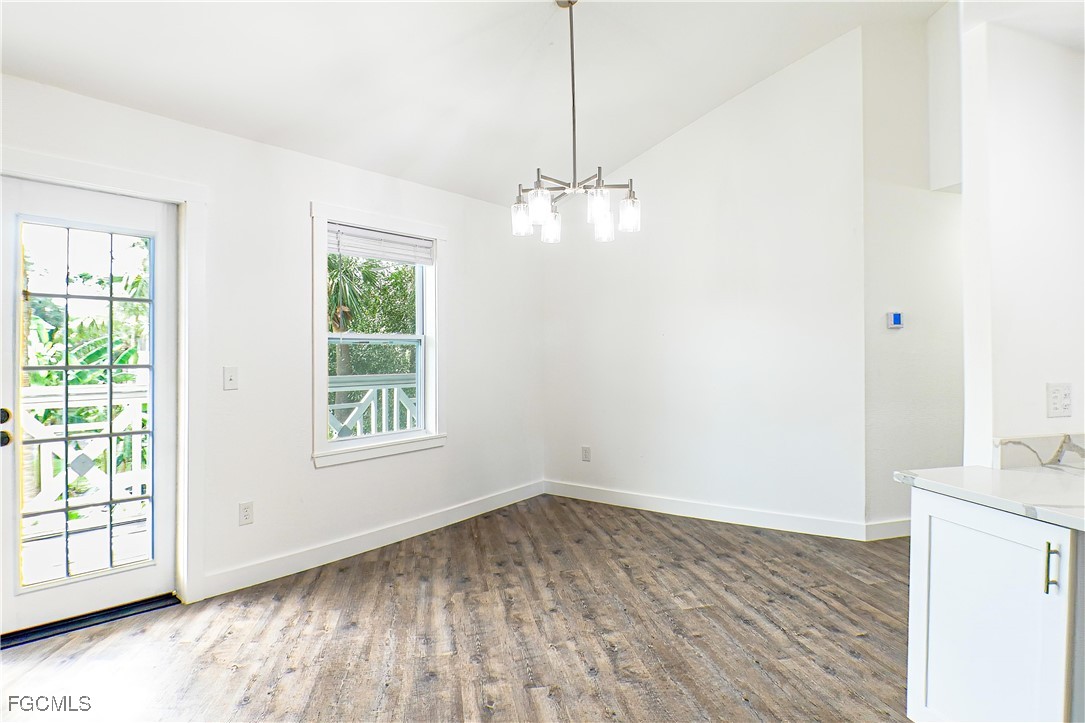 950 Moody Road, Unit 108 North Fort Myers, FL 33903 - Photo 6 of 21 wooden floor in an empty room with a window