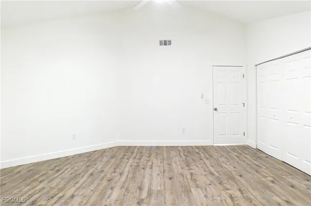 an empty room with wooden floor