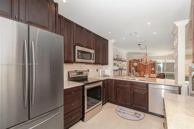 a kitchen with a sink appliances and cabinets