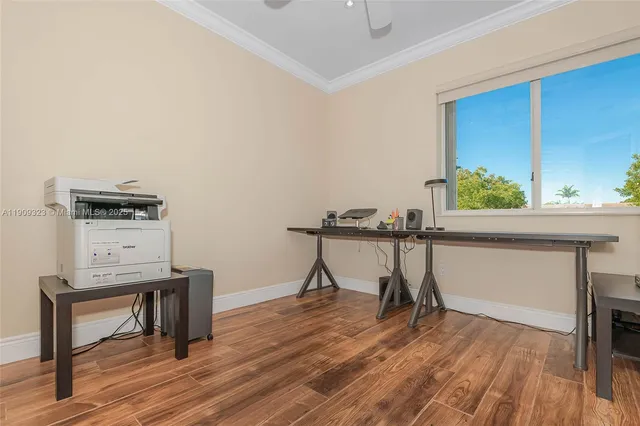 a view of a workspace with furniture and wooden floor