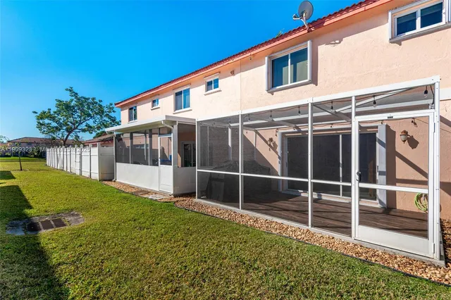 a backyard of a house with plants and outdoor seating