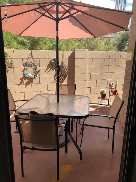 1987 East Del Rio Street Gilbert, AZ 85295 - Photo 27 of 28 a roof deck with table and chairs under an umbrella